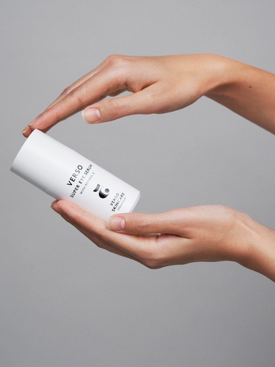 Verso Skincare No.5 Super Eye Serum Blos shop in hands of a model on a light grey background