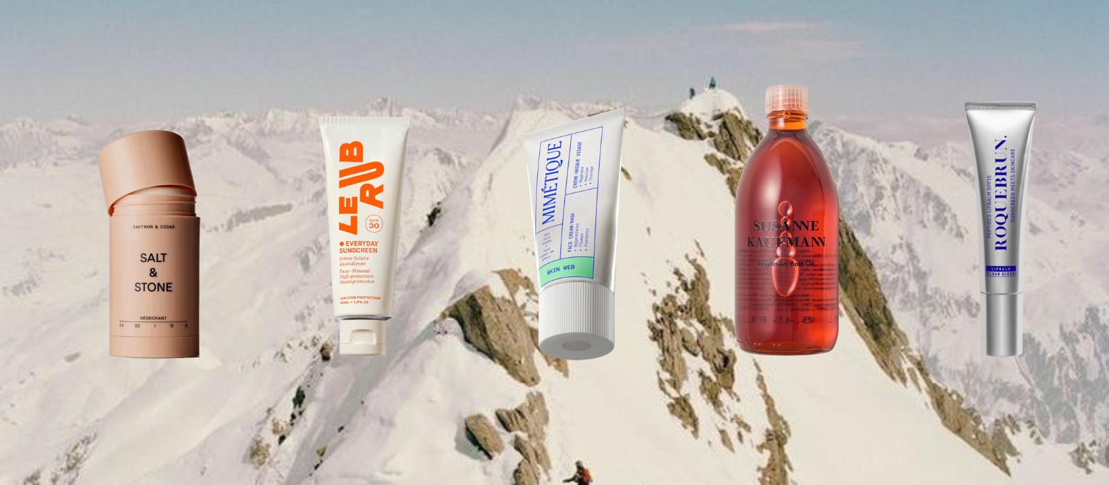 Collection of skincare products with mountainous background