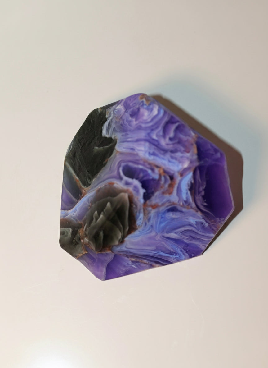 stone soap green and purple with wavy patterns on a white background