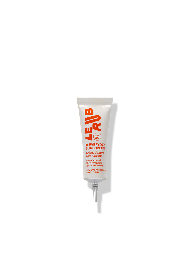 white tube with orange letters, facial sunscreen on white background 