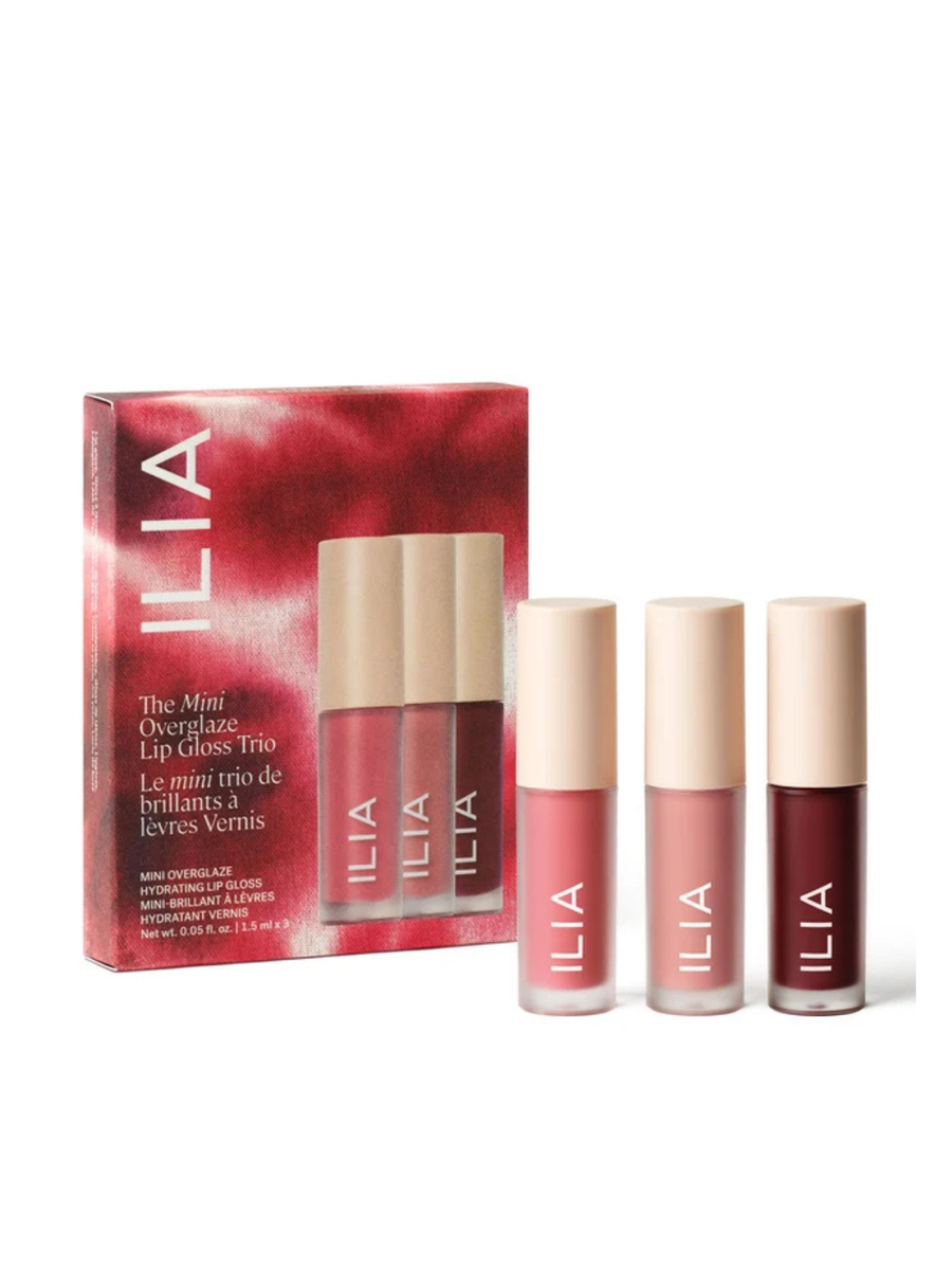 ILIA Mini Overlake Lip Gloss Trio set, featuring three lip gloss tubes in pink, nude, and deep berry shades with beige caps, displayed next to their red and pink packaging box on a white background.