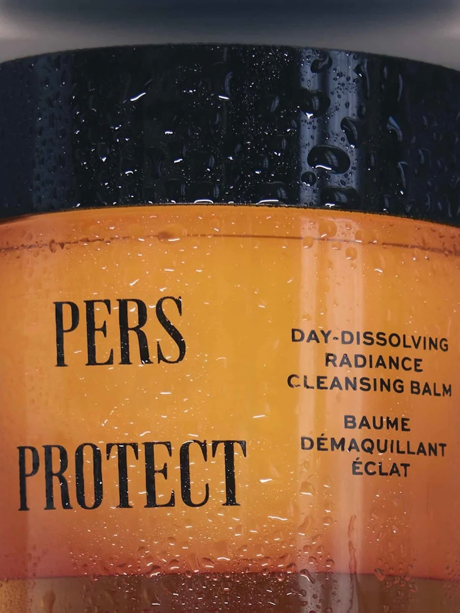 Jar of 'PERS PROTECT' day-dissolving radiance cleansing balm with black and yellow label.