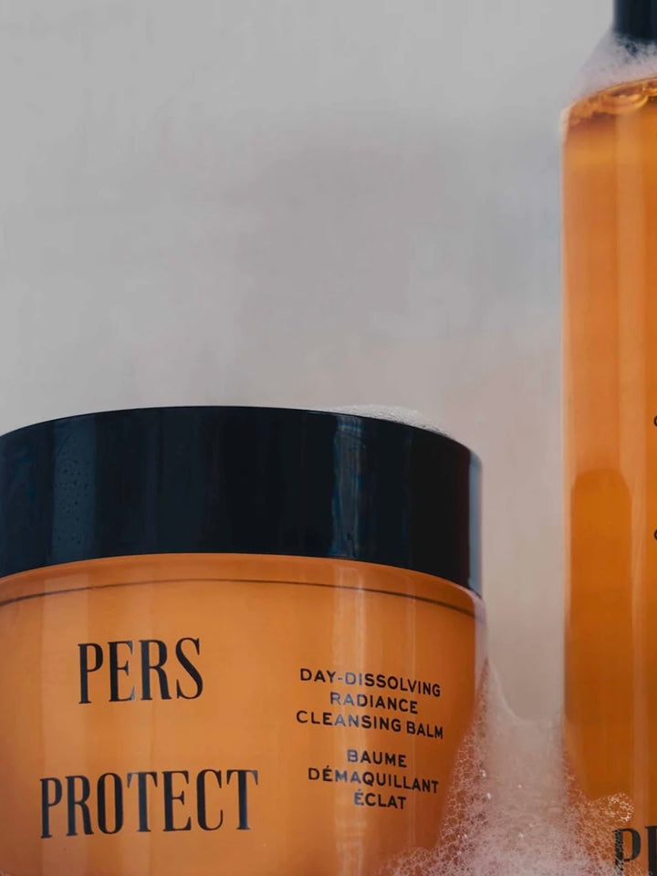 Jar of 'PERS PROTECT' cleansing balm with a bottle in the background