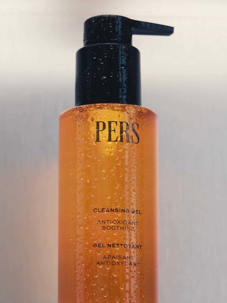Bottle of Pers cleansing gel with pump on a gradient background