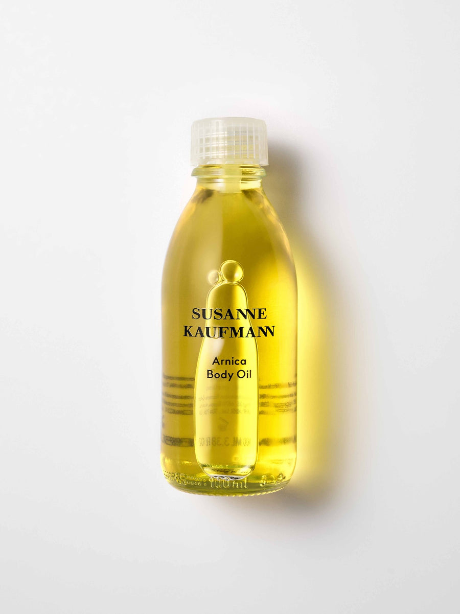 Bottle of Susanne Kaufmann Arnica Body Oil on a white background