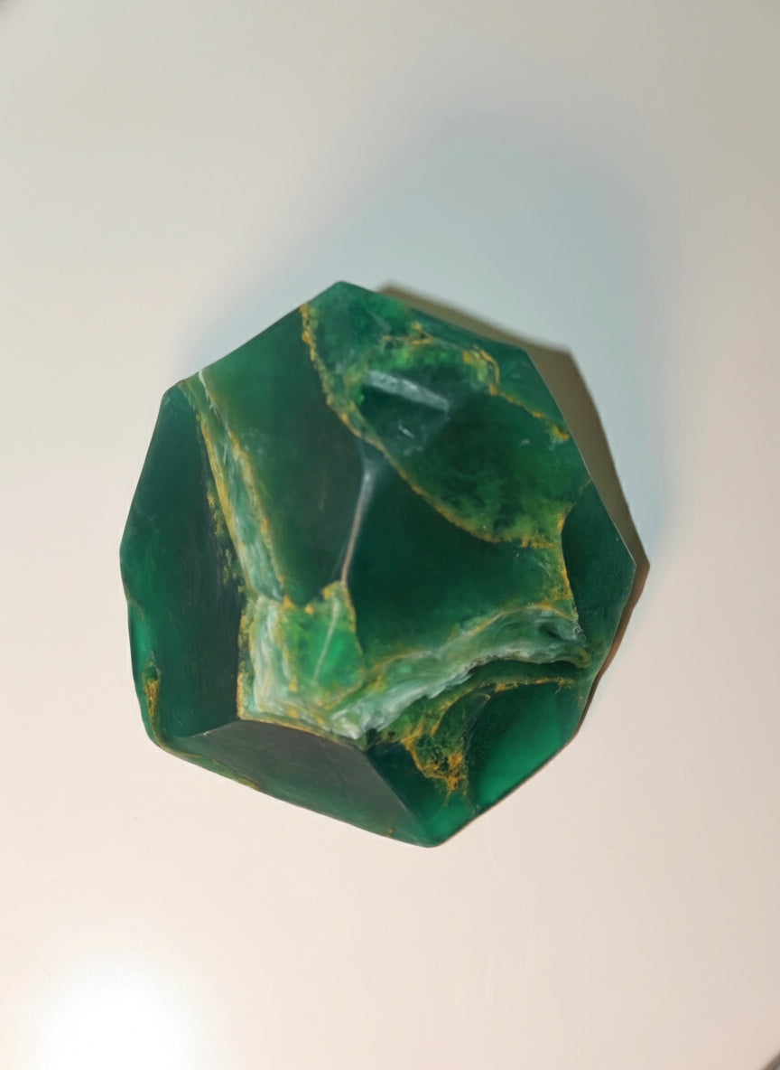 Green stoap stone on a light gray background