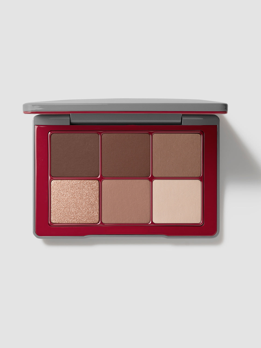 A six-shade eyeshadow palette with a deep red case and a gray lid, shown open on a light gray background.