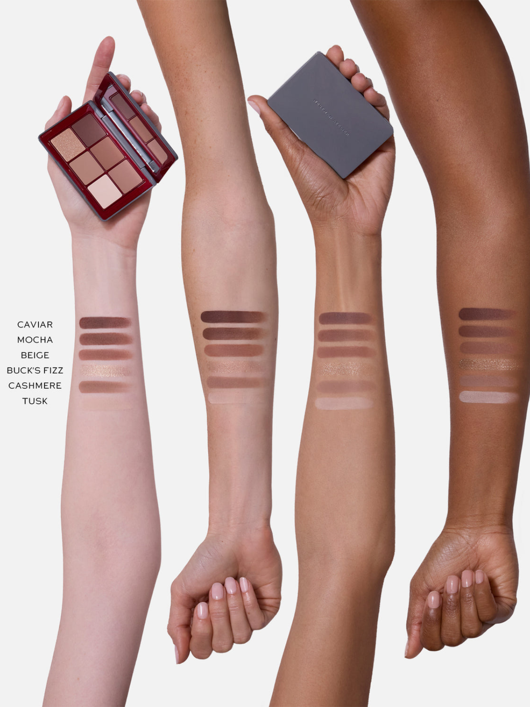 Four vertical arm swatches showing different skin tones, each with horizontal makeup swatches and text labels reading Caviar, Mocha, Beige, Buck's Fizz, Cashmere, and Tusk. Two hands also hold makeup palettes, one open with a red case and one closed in a dark gray case, against a light gray background.