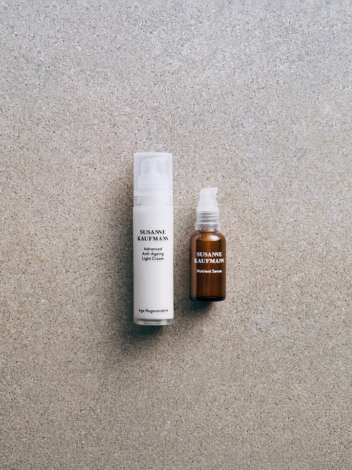 Two skincare products from Susanne Kaufmann on a textured gray surface