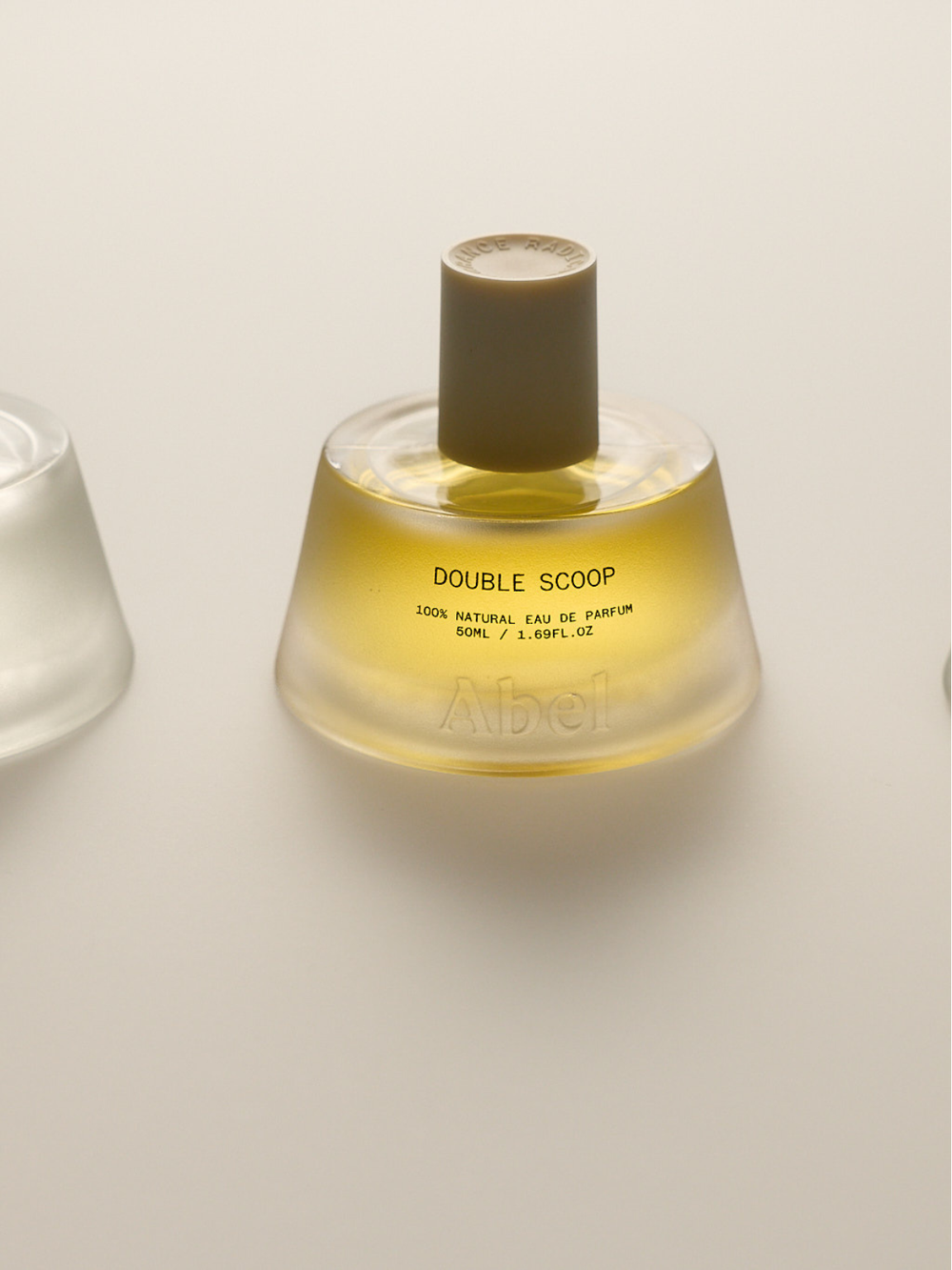 Perfume bottle labeled 'Double Scoop' on a light background