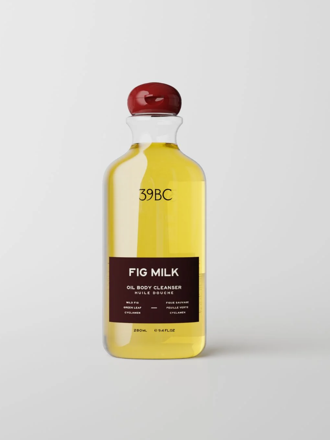 A 250ml glass bottle of 39BC Fig Milk Oil Body Cleanser, filled with a golden yellow liquid and featuring a dark brown label with a glossy red cap, set against a light gray background.