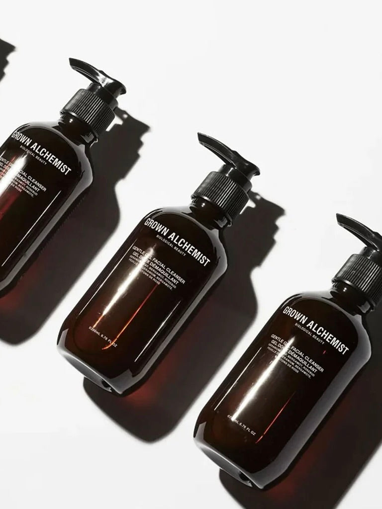 Three bottles of Grown Alchemist products on a white background