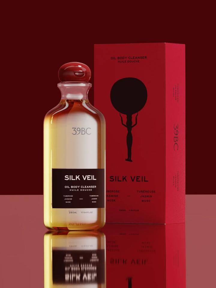 Silk Veil oil body cleanser bottle and packaging on a red background