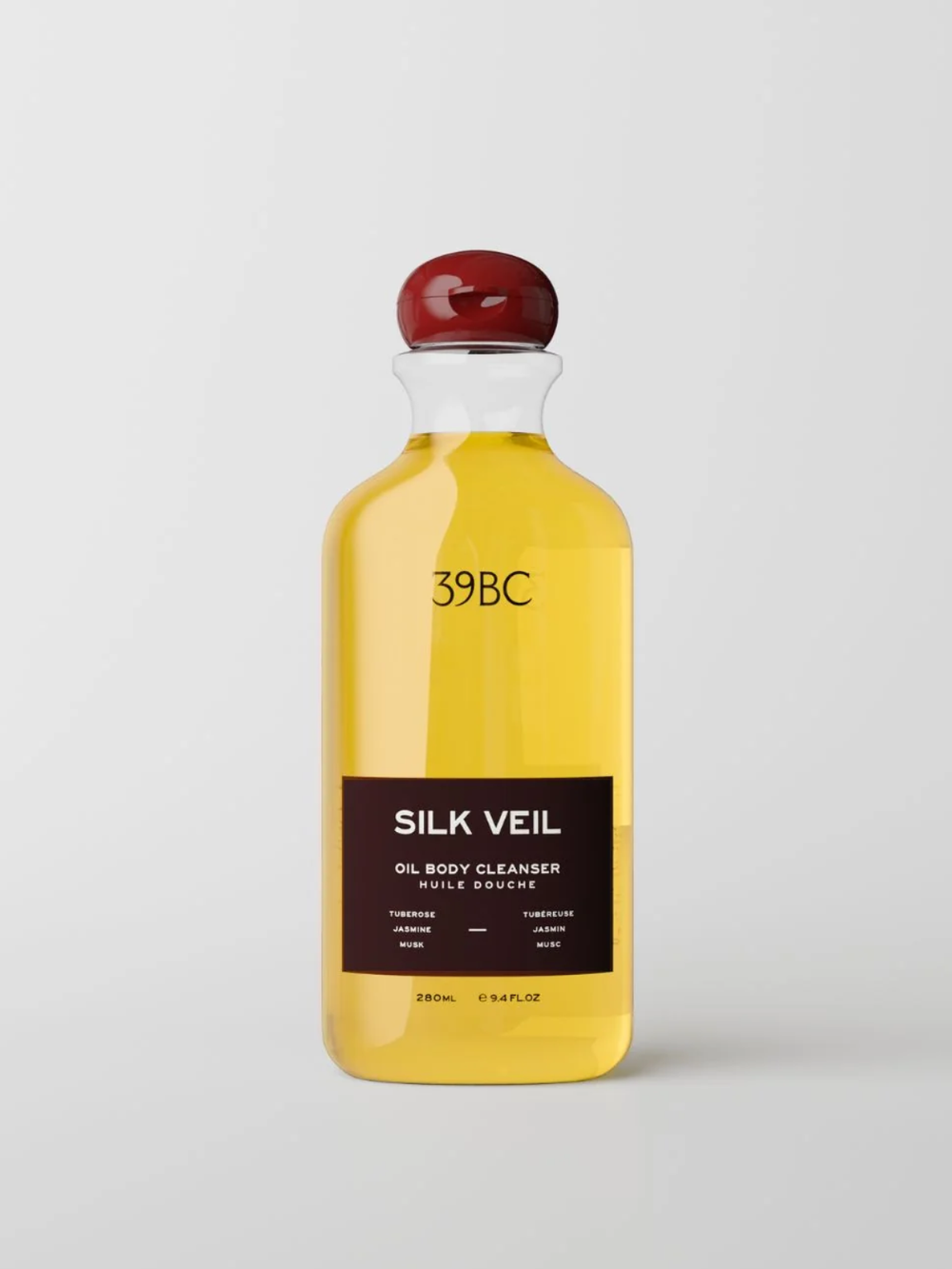 A 280ml clear bottle of 39BC Silk Veil Oil Body Cleanser filled with golden yellow liquid, featuring a dark brown label and a glossy dark red cap, set against a light gray background.